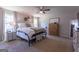 Cozy main bedroom with a ceiling fan, decor, windows with natural light, and a large bed at 101 Greenfield Ln, Grantville, GA 30220