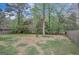 Spacious backyard with a partial fence line and mature trees, perfect for outdoor activities at 106 Gateway Pt, Peachtree City, GA 30269