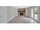 Open basement area with gray walls, fireplace with stone surround, and wood-look flooring at 106 Gateway Pt, Peachtree City, GA 30269