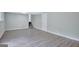 Finished basement with gray walls and gray flooring leads to stairs and a white door at 106 Gateway Pt, Peachtree City, GA 30269