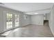 Finished basement with wood-look flooring, door to stairs, and french doors to outdoors at 106 Gateway Pt, Peachtree City, GA 30269