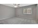This is a bedroom with carpet, a ceiling fan, and a window with wood blinds at 106 Gateway Pt, Peachtree City, GA 30269