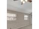 Bedroom featuring neutral walls, carpet, two windows, and ceiling fan with light fixture at 106 Gateway Pt, Peachtree City, GA 30269