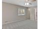 Bright bedroom features neutral walls, carpet, and a window with wood blinds at 106 Gateway Pt, Peachtree City, GA 30269