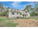 Back exterior of house with white siding, windows, and door leading to a large backyard space at 106 Gateway Pt, Peachtree City, GA 30269