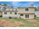 Exterior rear view of the home showcasing its white siding, windows, doors and yard at 106 Gateway Pt, Peachtree City, GA 30269