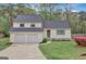 Inviting two-story home with a two-car garage, front lawn, and manicured greenery at 106 Gateway Pt, Peachtree City, GA 30269