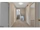 Hallway featuring neutral walls and carpet, with a view of stairs and bedroom doors at 106 Gateway Pt, Peachtree City, GA 30269