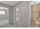 Hallway leading to a bedroom with neutral walls, a bathroom, and neutral carpet at 106 Gateway Pt, Peachtree City, GA 30269