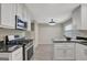 The kitchen features stainless steel appliances, granite countertops and white cabinetry at 106 Gateway Pt, Peachtree City, GA 30269