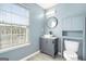 Modern bathroom with gray vanity, stylish sink, and a large window at 6887 Slate Stone Se Way # 3, Mableton, GA 30126
