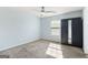 Bright bedroom with a ceiling fan, closet, and large window at 6887 Slate Stone Se Way # 3, Mableton, GA 30126