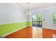 Bright dining room with green accent wall, hardwood floors, and access to a outdoor patio at 6887 Slate Stone Se Way # 3, Mableton, GA 30126