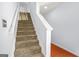 Carpeted staircase with a white banister and hardwood landing at 6887 Slate Stone Se Way # 3, Mableton, GA 30126