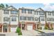 Exterior view of charming townhomes with brick accents and attached garages on a sunny day at 6887 Slate Stone Se Way # 3, Mableton, GA 30126