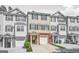 Exterior view of charming townhomes with brick accents and attached garages on a sunny day at 6887 Slate Stone Se Way # 3, Mableton, GA 30126