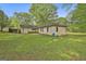 Spacious backyard with mature trees, offering a peaceful retreat and ample space for outdoor activities at 2008 Highway 92 S, Fayetteville, GA 30215