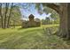 A charming barn sits on a lush lawn, with an outdoor table set nearby for enjoying the serene surroundings at 2008 Highway 92 S, Fayetteville, GA 30215