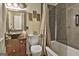 Cozy bathroom featuring unique vanity sink, decorative mirror and a tub with a shower at 2008 Highway 92 S, Fayetteville, GA 30215