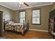 Inviting bedroom with warm wood floors, neutral walls, and two windows providing plenty of natural light at 2008 Highway 92 S, Fayetteville, GA 30215