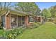 Brick home with screened porch and lush landscaping, providing a serene and inviting curb appeal at 2008 Highway 92 S, Fayetteville, GA 30215