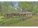 Attractive brick home with well-tended landscaping and a charming wooden fence surrounding the property at 2008 Highway 92 S, Fayetteville, GA 30215