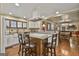 Open-concept kitchen boasts granite counters, an island with seating, and modern lighting at 2008 Highway 92 S, Fayetteville, GA 30215