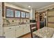 Kitchen featuring granite countertops, custom cabinets, and wooden shutters at 2008 Highway 92 S, Fayetteville, GA 30215