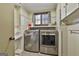 Well-lit laundry room featuring modern stainless steel appliances and ample storage space at 2008 Highway 92 S, Fayetteville, GA 30215