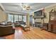 Inviting living room featuring a stone fireplace, hardwood floors, and large windows for natural light at 2008 Highway 92 S, Fayetteville, GA 30215