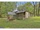 Backyard shed featuring a swing and porch surrounded by mature trees and greenery, providing storage at 2008 Highway 92 S, Fayetteville, GA 30215