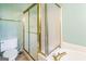 Bathroom with a white toilet, frosted glass shower and gold trim at 675 Granby Hill Pl, Alpharetta, GA 30022