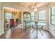 Breakfast nook with glass table, chandelier, and view into dining room at 675 Granby Hill Pl, Alpharetta, GA 30022
