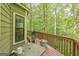Green sided deck with a grill, table, wooden railing, and tree view at 675 Granby Hill Pl, Alpharetta, GA 30022