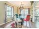 Formal dining room with glass-top table, stylish chairs, and view of the backyard at 675 Granby Hill Pl, Alpharetta, GA 30022