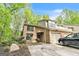 Two-story brick home featuring an attached garage, arched entryway, and mature trees at 675 Granby Hill Pl, Alpharetta, GA 30022