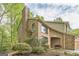 Charming brick home with mature trees and landscaping, featuring an attached garage and arched window at 675 Granby Hill Pl, Alpharetta, GA 30022