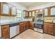 Well-lit kitchen featuring wood cabinets, stainless steel appliances, and a double sink at 675 Granby Hill Pl, Alpharetta, GA 30022