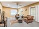 A traditional living room features carpet floors, two chairs, and a ceiling fan at 675 Granby Hill Pl, Alpharetta, GA 30022