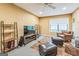 This living room features a TV, ceiling fan, and two brown upholstered chairs at 675 Granby Hill Pl, Alpharetta, GA 30022