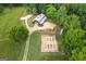 Expansive aerial view of farm, barn and garden on a tree-filled lot at 238 Indian Creek Rd, Locust Grove, GA 30248