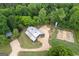 An aerial view showcases the house, gardens, surrounding property and the lovely wooded area at 238 Indian Creek Rd, Locust Grove, GA 30248
