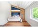 Cozy bedroom with custom built-in bunk beds, wood floors, a barn door and a sunny window at 238 Indian Creek Rd, Locust Grove, GA 30248
