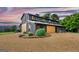 Striking barn conversion with rustic wood siding, garden boxes, and gravel driveway at 238 Indian Creek Rd, Locust Grove, GA 30248