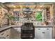 Charming kitchen featuring a stainless steel oven, stone walls, and custom shelving at 238 Indian Creek Rd, Locust Grove, GA 30248