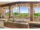 Charming kitchen featuring stone counters, a farmhouse sink, and a large window overlooking the landscape at 238 Indian Creek Rd, Locust Grove, GA 30248