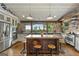 Spacious kitchen featuring a center island, stainless steel appliances, and stone walls at 238 Indian Creek Rd, Locust Grove, GA 30248