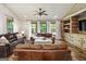 Comfortable living room with leather sofas, wood paneling, and bright natural light at 238 Indian Creek Rd, Locust Grove, GA 30248