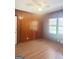 Cozy bedroom with paneled walls, laminate flooring, ceiling fan, and natural light at 6718 Delta Dr, Riverdale, GA 30274