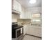 Well-lit kitchen with white cabinetry, laminate counters, and stainless steel appliances at 6718 Delta Dr, Riverdale, GA 30274